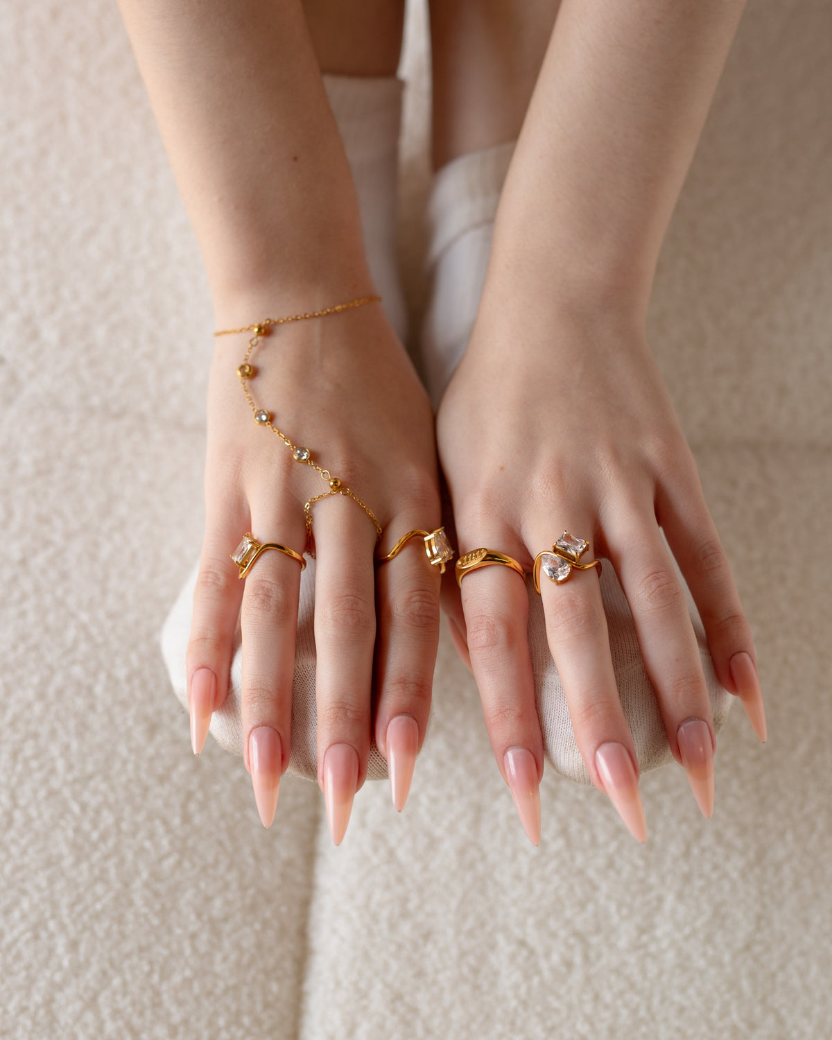 11:11 engraved gold ring styled with multiple rings and a gold hand chain.