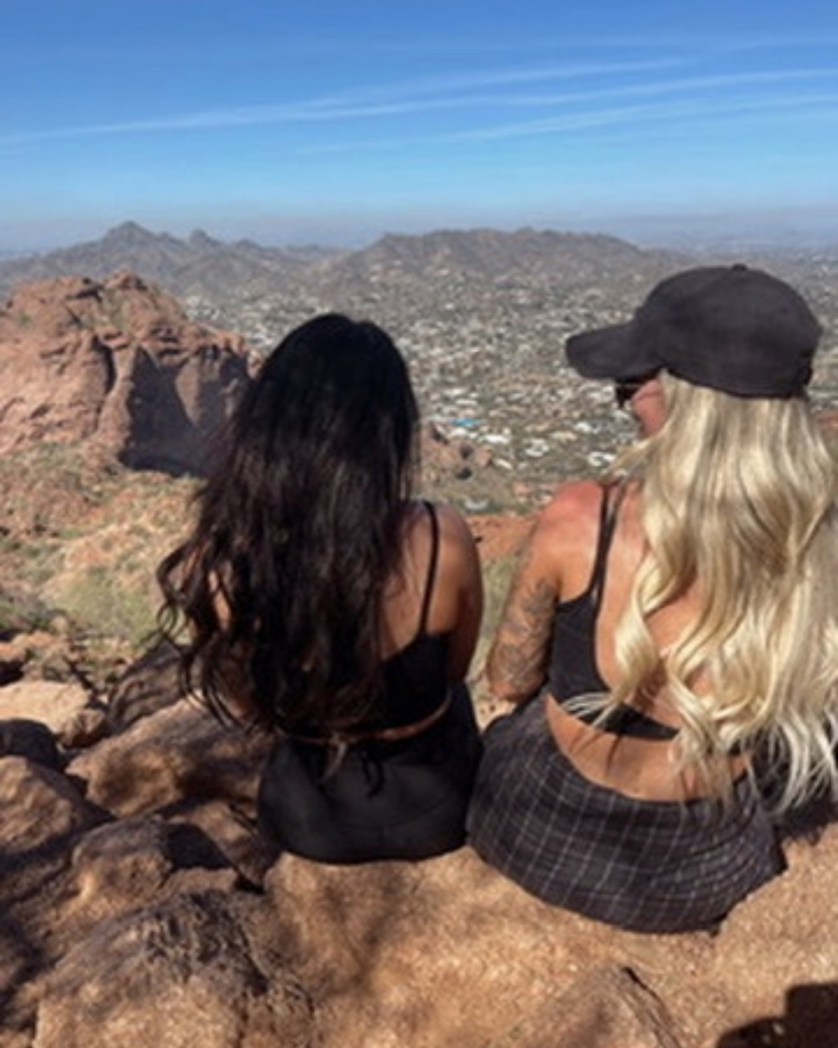 The KYELLA founders seated together overlooking a desert landscape