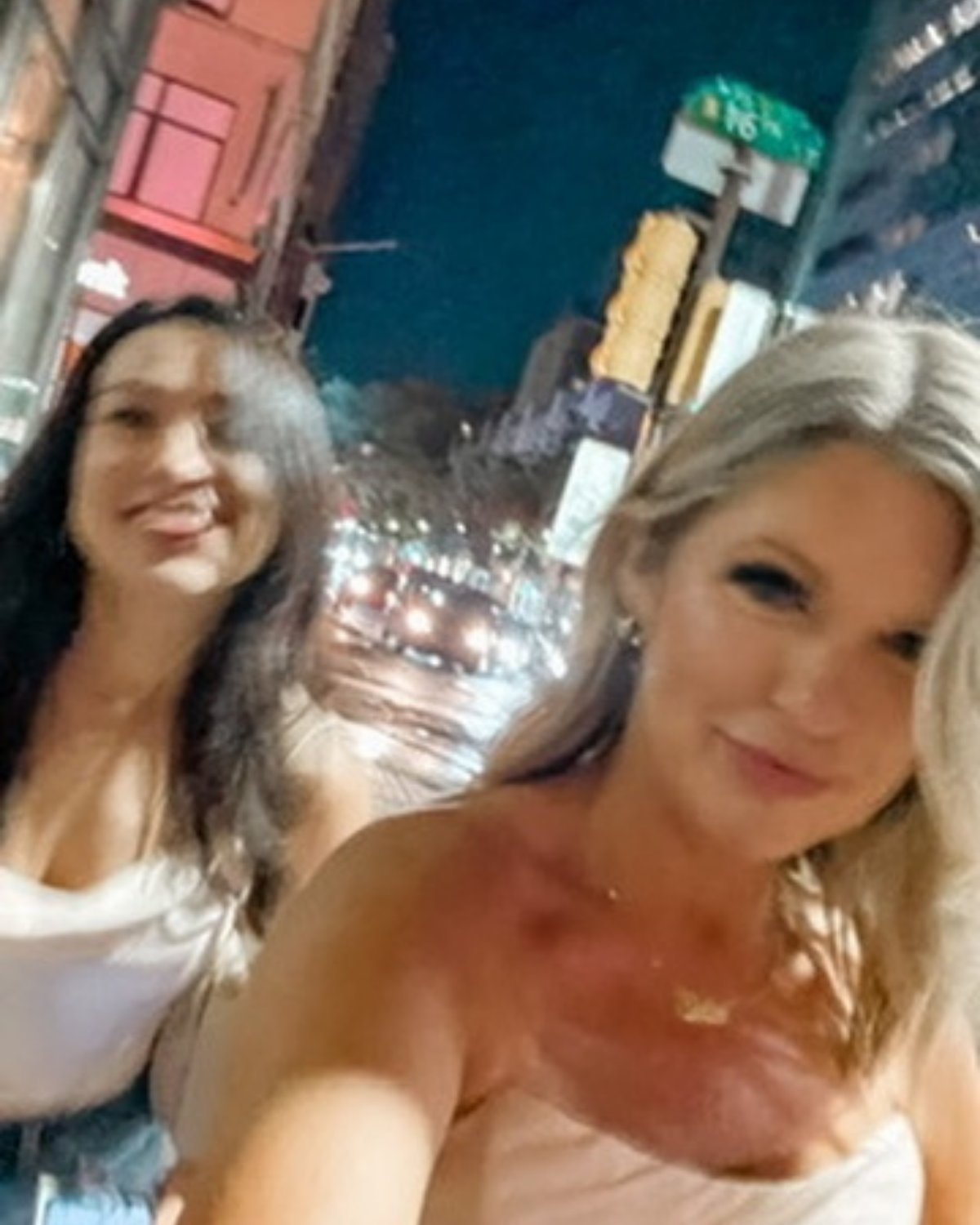 The KYELLA founders taking a nighttime city selfie