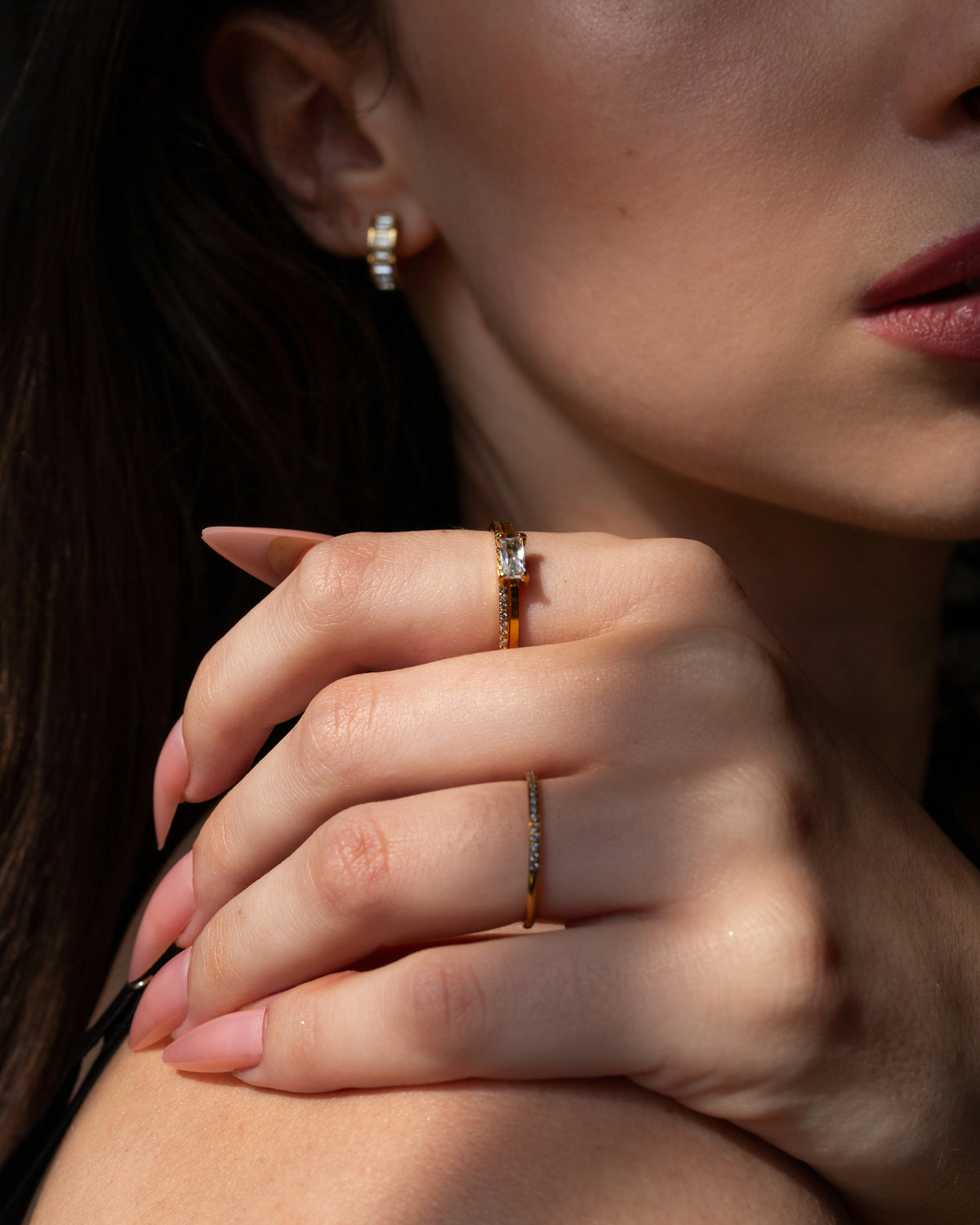 Aura gold pavé stacking ring worn in a close hand portrait.