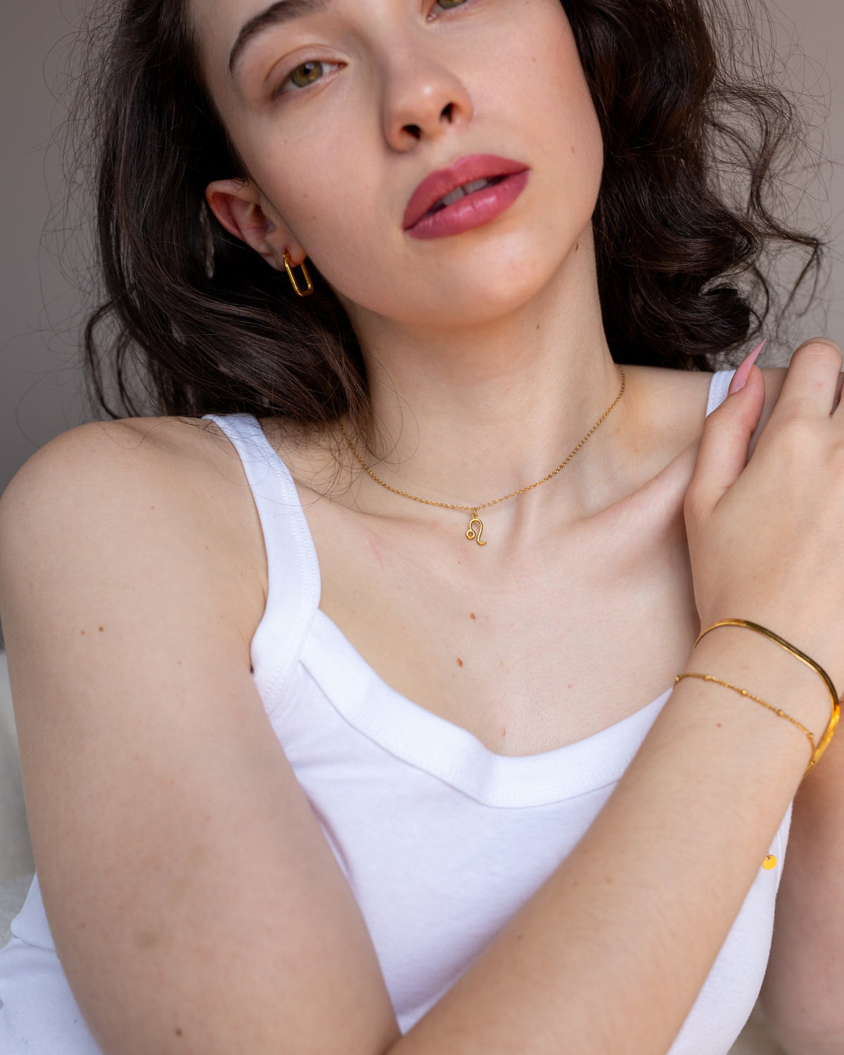 Circe gold rectangular hoops styled in a full lifestyle portrait.