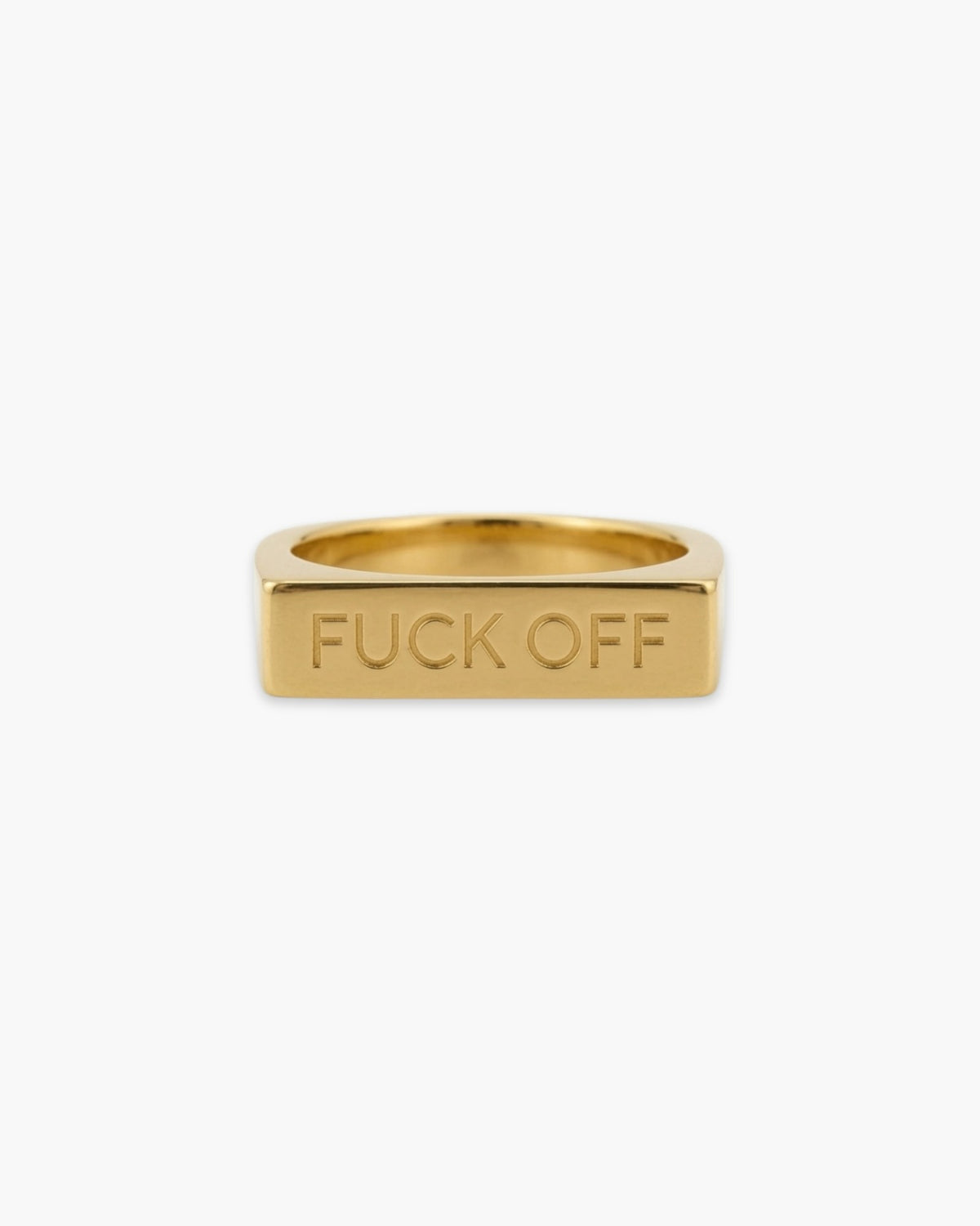Polished gold-tone rectangular signet ring engraved with “FUCK OFF” on a white background.