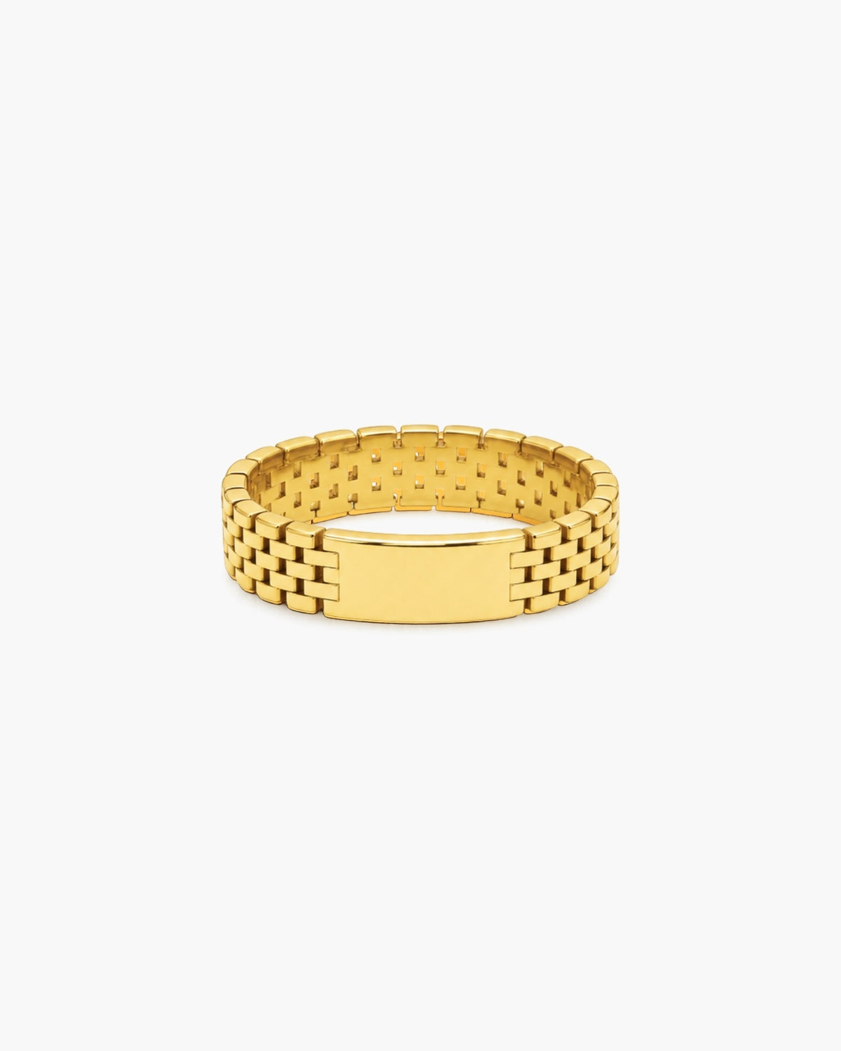 Wide polished gold-tone Harmonia ring with watchband-inspired brick links and a smooth rectangular center plate on a white background.