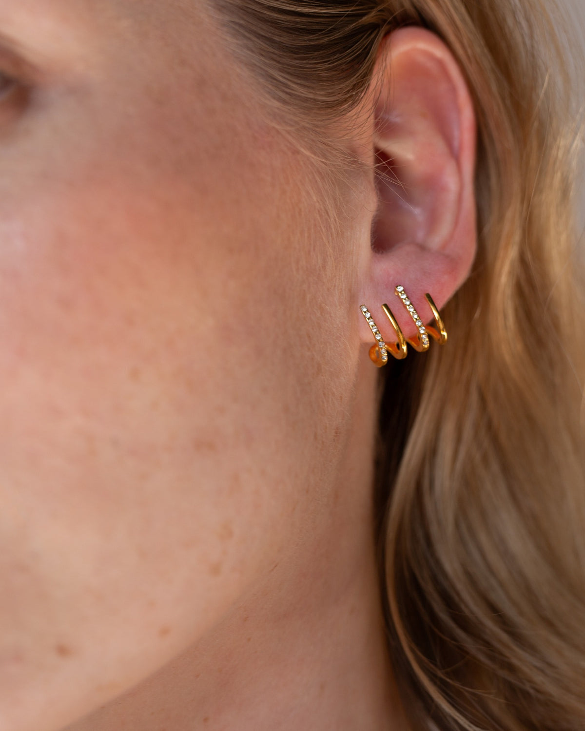 Hedy gold pavé ear cuff shown in a tight ear-detail view.