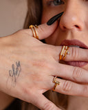 Helen clear-stone dangle ring worn with black nails in a tight hand-to-face jewelry detail.