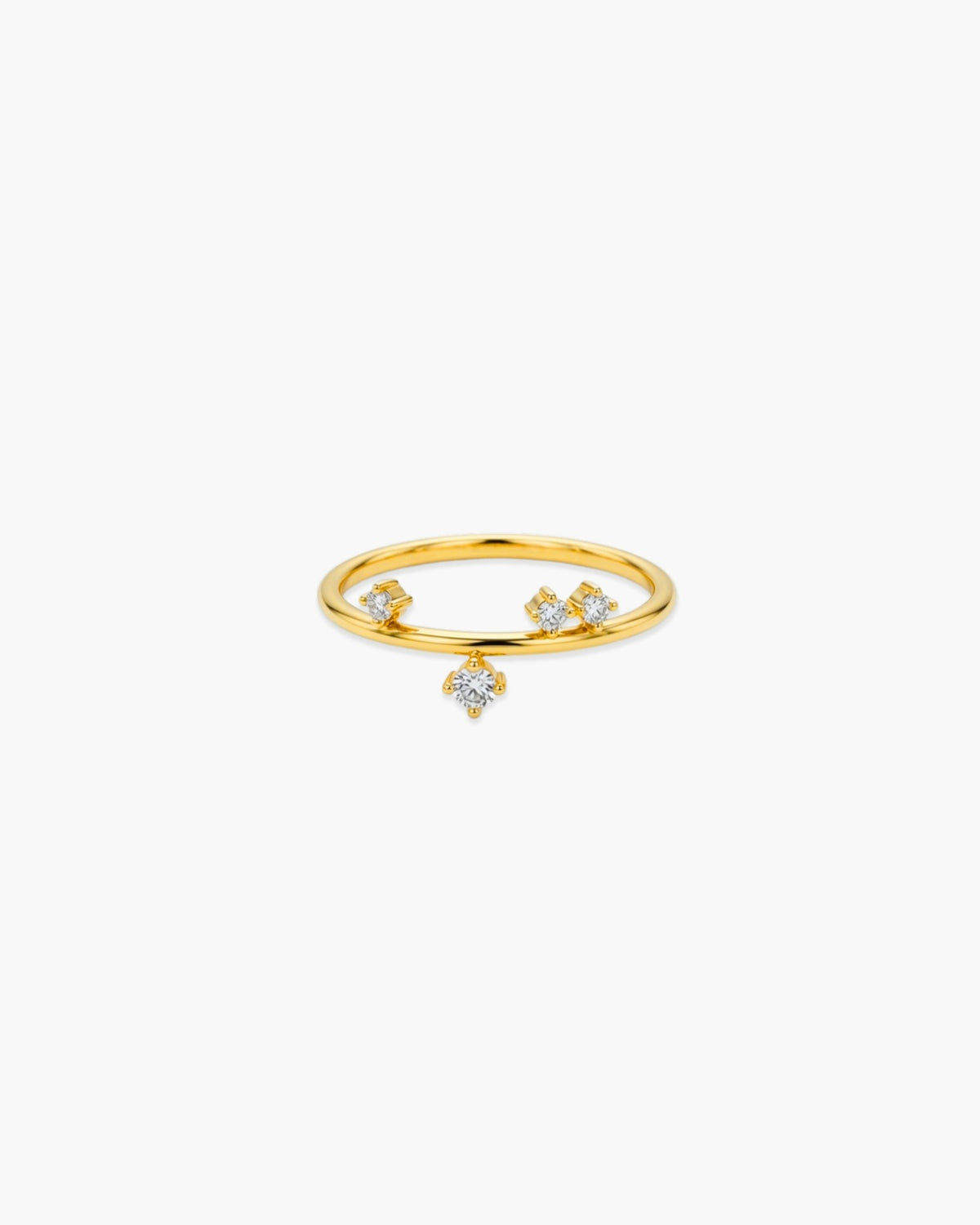 Slim gold-tone Helen ring with scattered clear stones and one dangling center stone on a white background.