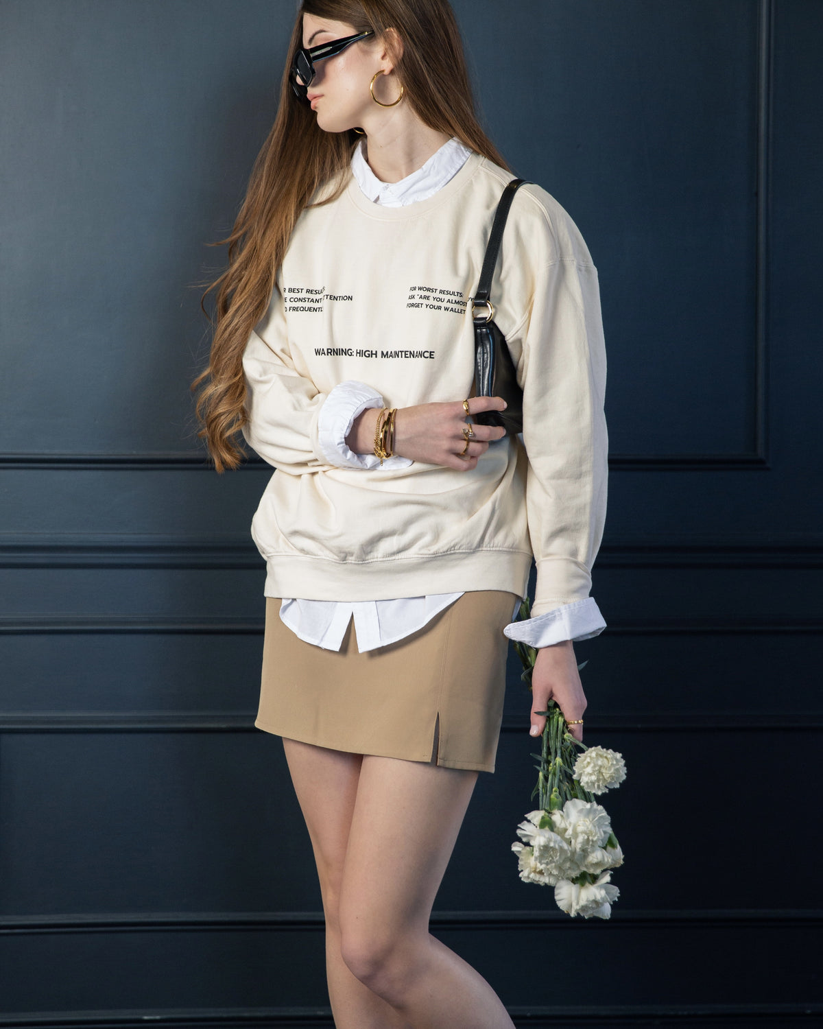 Supporting image of the cream High Maintenance crewneck sweatshirt.