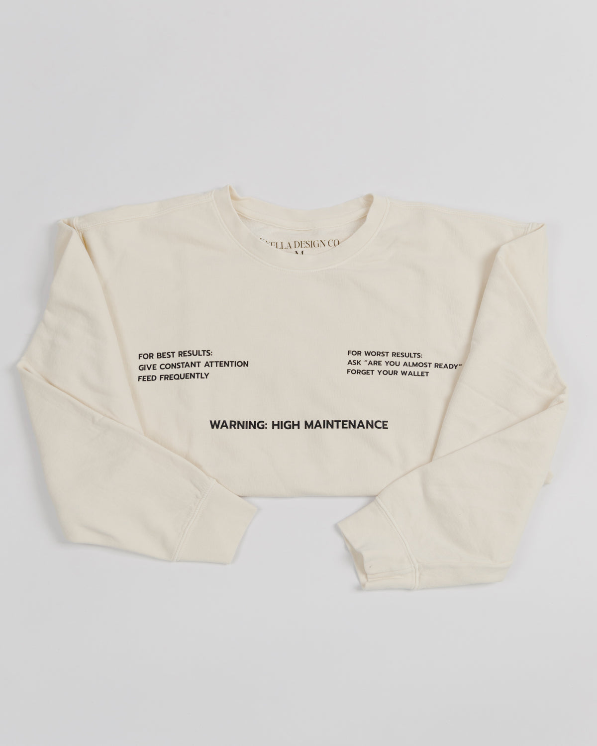 Cream High Maintenance crewneck sweatshirt worn by a model.