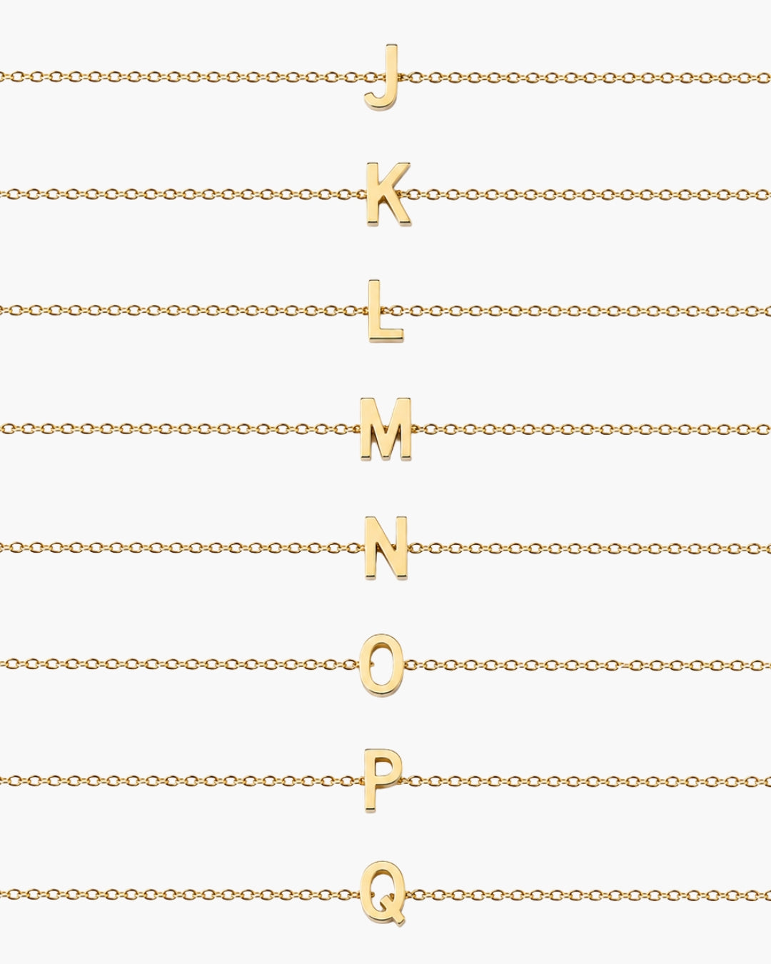 Initial Necklace letters J through Q arranged on gold chains on a white background.