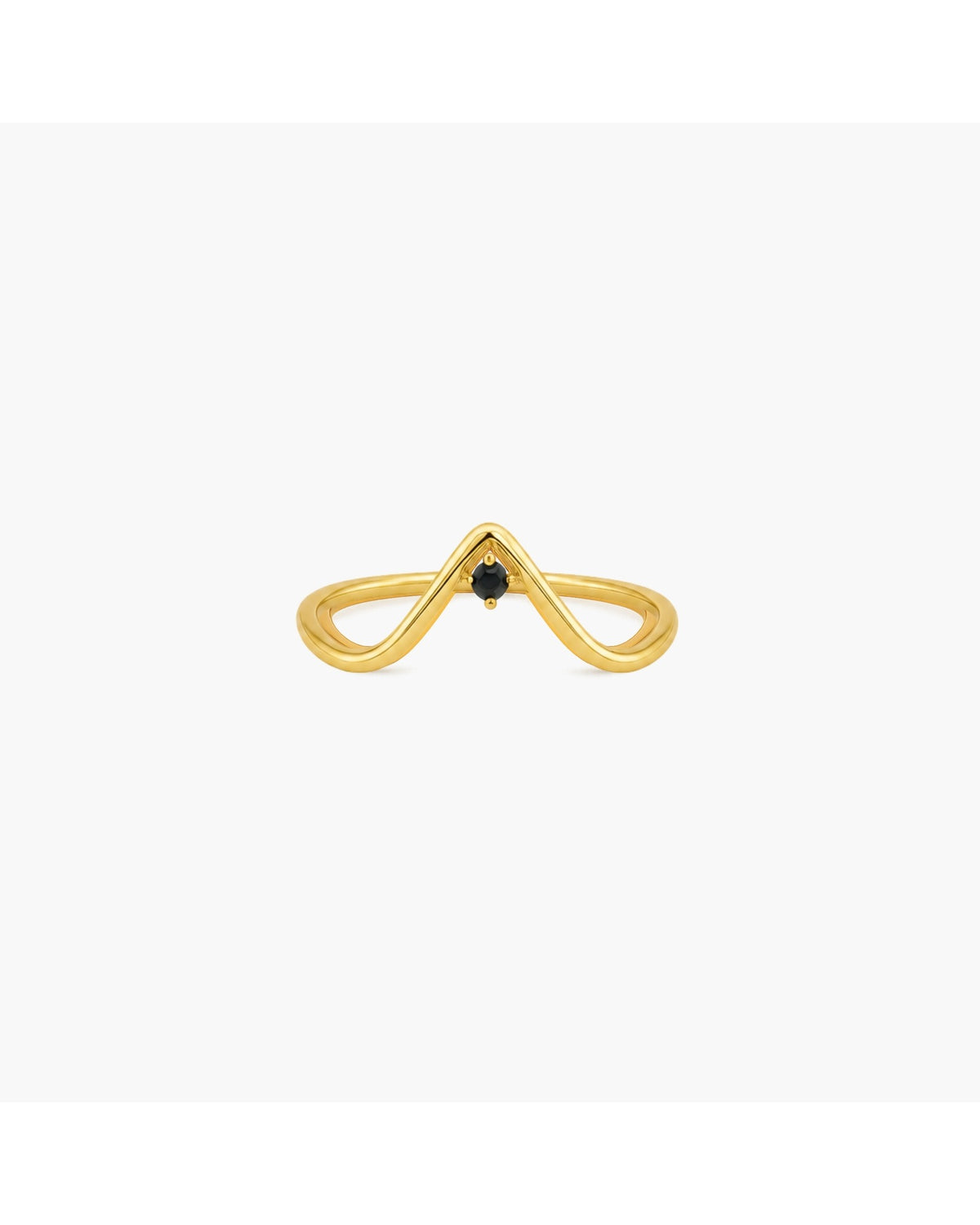 Gold-tone Manto sculptural wave ring with an open double-band silhouette and a small black pear-shaped stone on a white background.