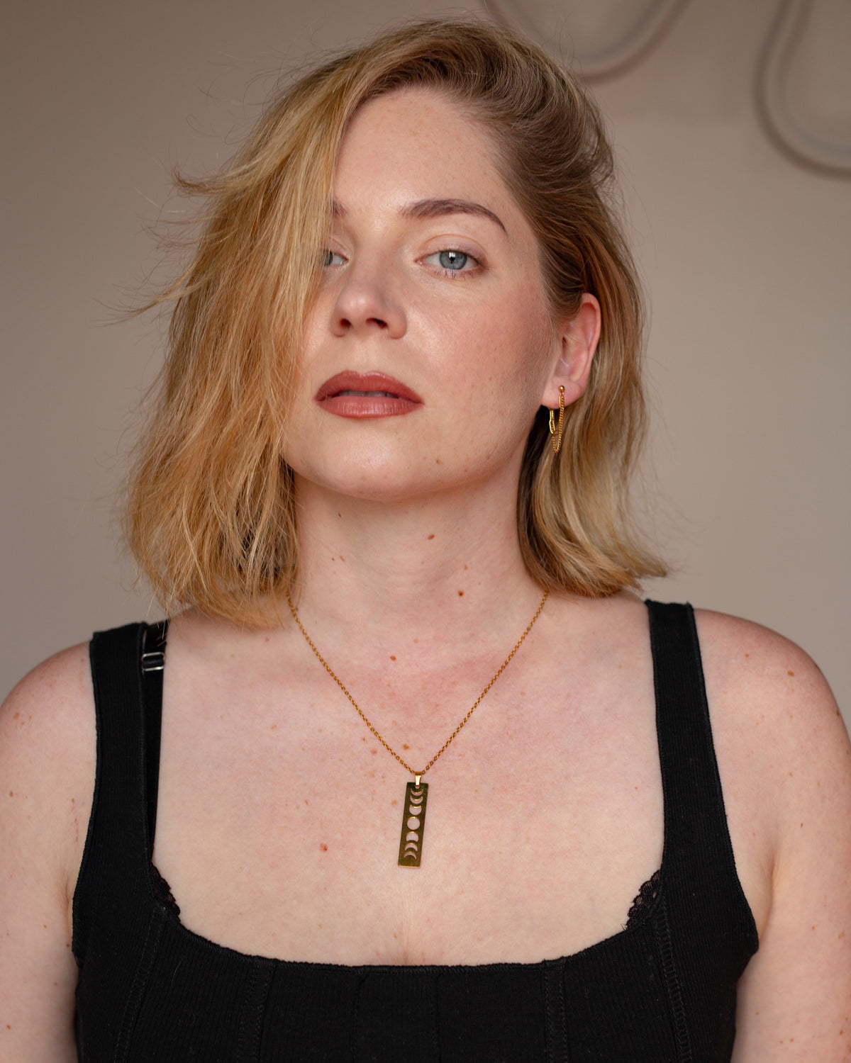Melinoe gold layered chain earring styled in a full portrait.