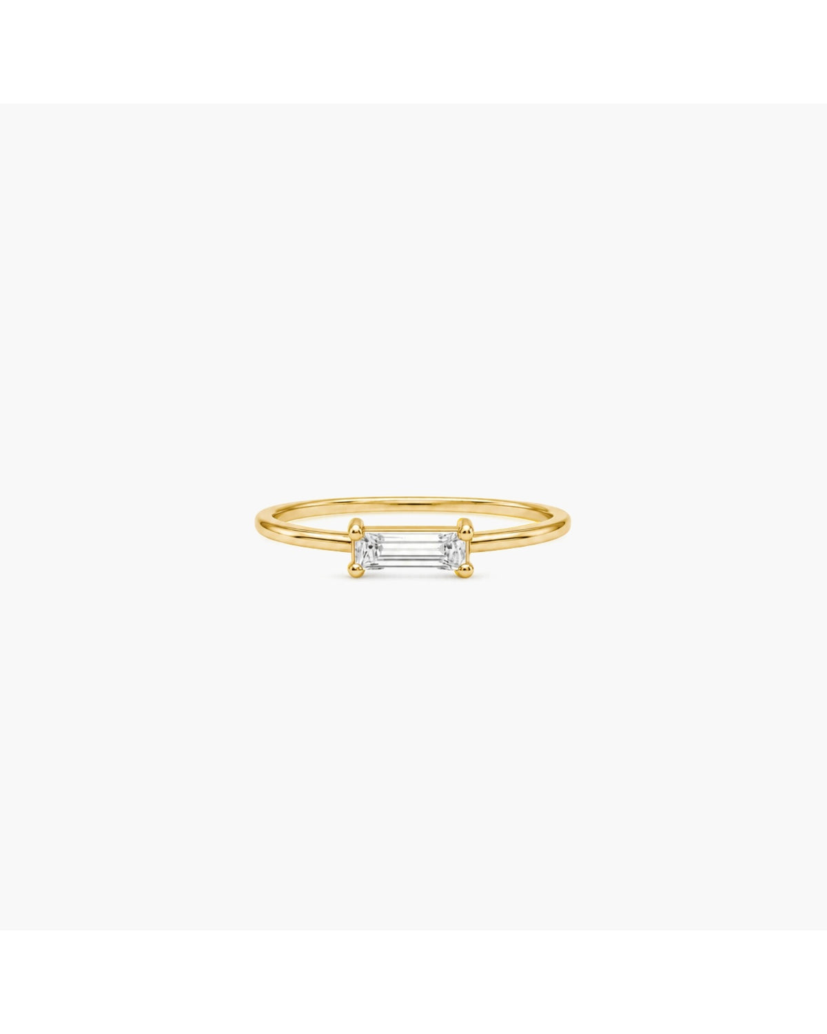 Gold-tone Nelle double-band ring with a horizontally set rectangular clear stone on a white background.