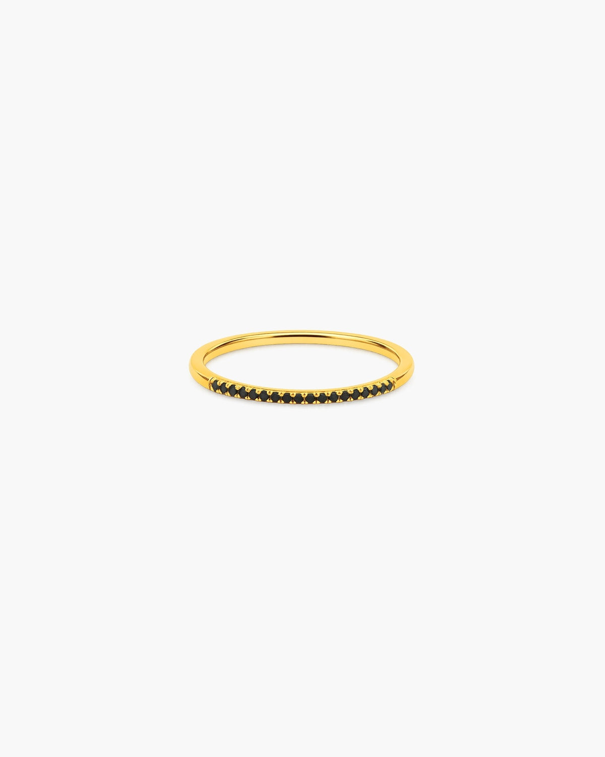 Slim gold-tone Nyx stacking ring with a front row of small black pavé-style stones on a white background.
