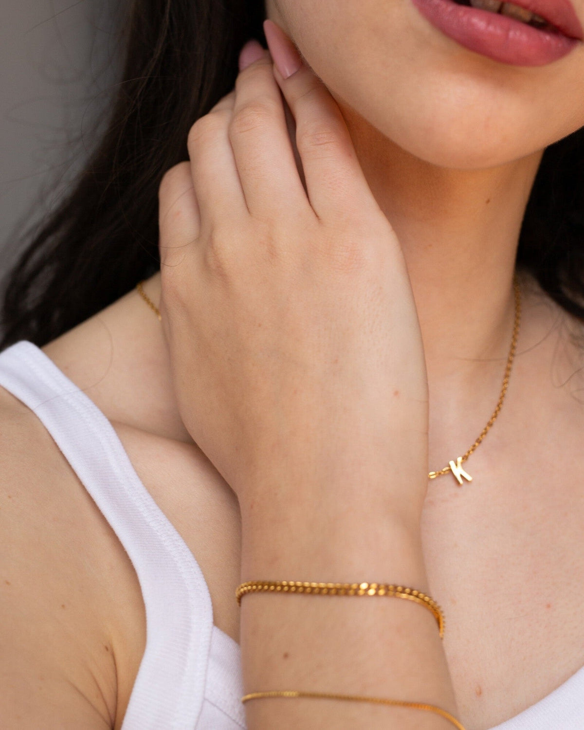 Penelope Bracelet, an 18K Gold PVD box chain bracelet worn in a close portrait.