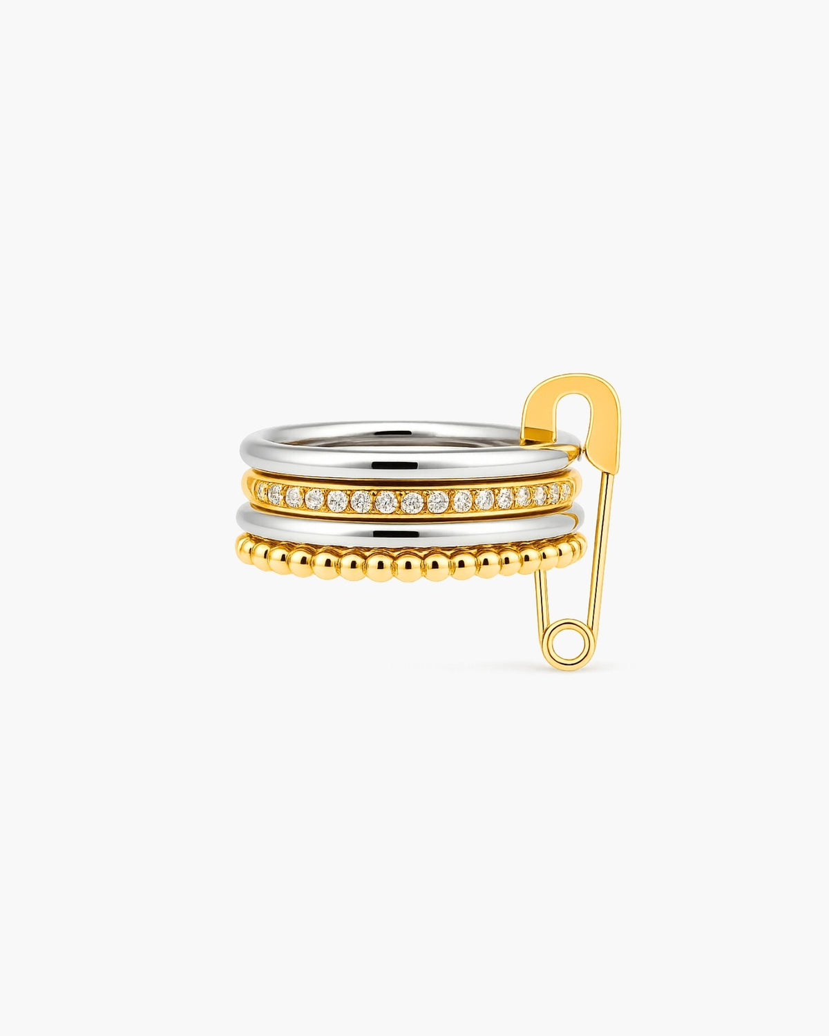 Phoebe mixed-metal stacked ring with clear stones and an oversized gold safety-pin accent on a white background.