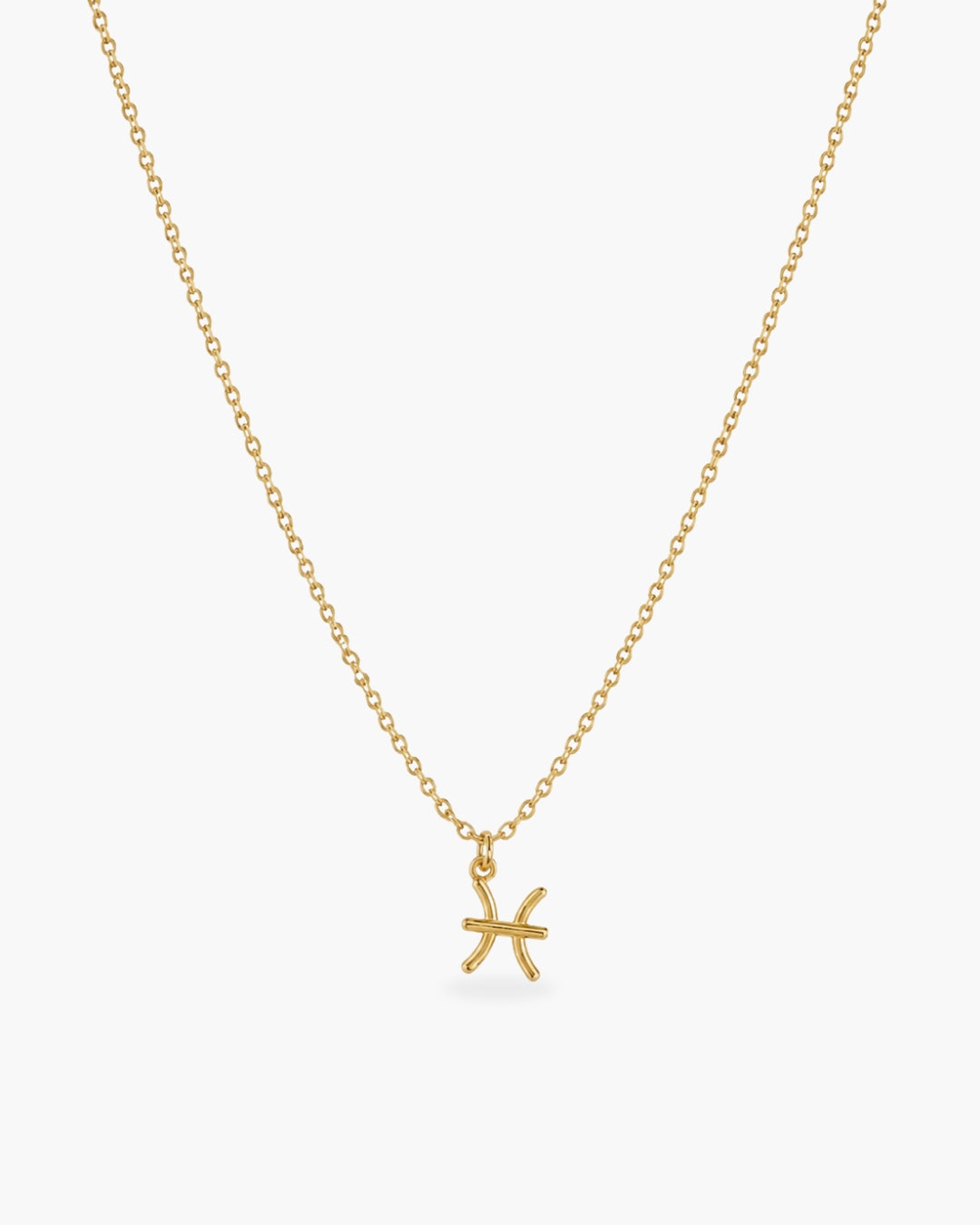 Gold-tone Pisces zodiac pendant necklace on a fine adjustable chain.